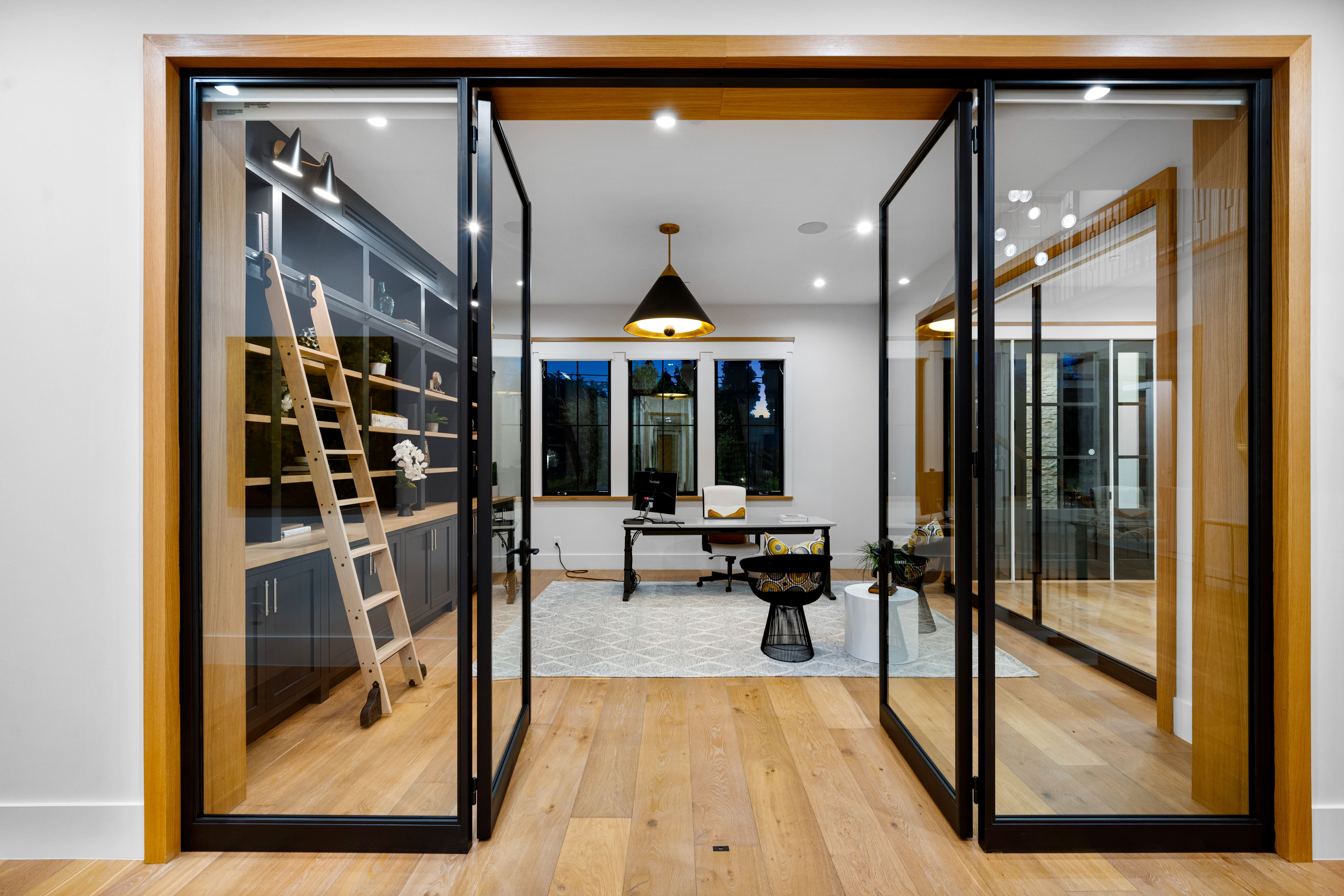 Slim-framed pivot door installation with glass panels